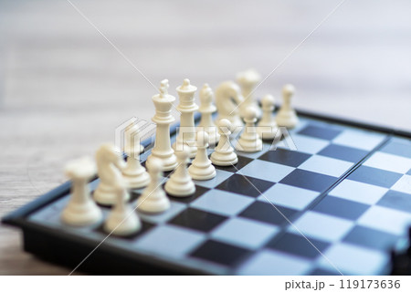 Closeup of a chess board with white and black pieces Closeup of a chess board with white and black pieces 119173636