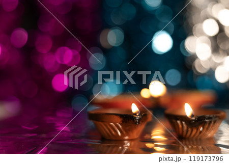 Close-up of decorated diyas during Diwali on bokeh background. 119173796