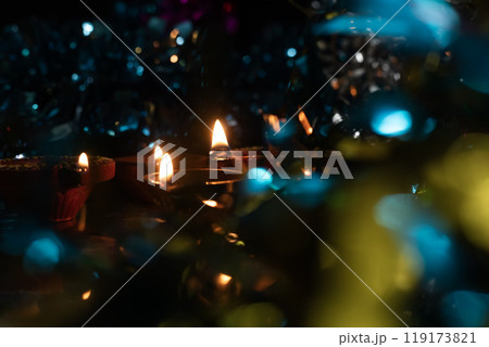 Diwali festival celebration background with glowing diyas with bright color bokeh. 119173821