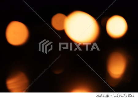 Abstract blurred warm bokeh lights against a dark background. 119173853