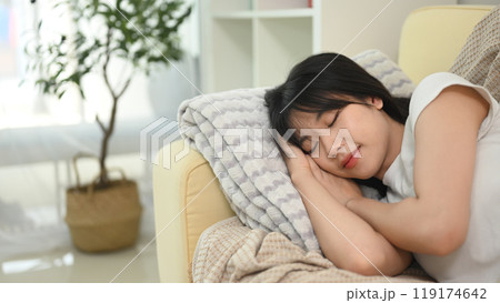 Young beautiful asian woman sleeping on couch at home 119174642