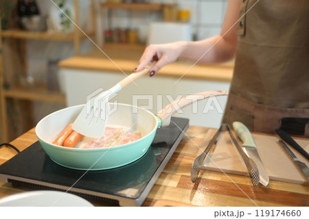 Cropped shot of young woman preparing breakfast in her kitchen Cropped shot of young woman preparing breakfast in her kitchen 119174660