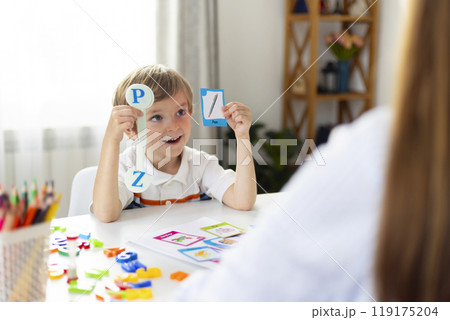 Boy learning letters in classroom setting 119175204