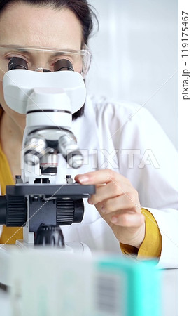 Woman scientist using microscope in laboratory. Microbiology science concept 119175467