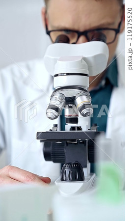 Man scientist using microscope in laboratory. Microbiology science concept Man scientist using microscope in laboratory. Microbiology science concept 119175520
