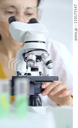 Woman scientist using microscope in laboratory. Microbiology science concept Woman scientist using microscope in laboratory. Microbiology science concept 119175547