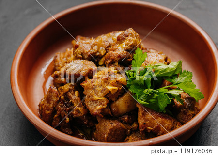 Traditional homemade roasted meat with onions and greens, food photography and culinary blogs Traditional homemade roasted meat with onions and greens, food photography and culinary blogs 119176036