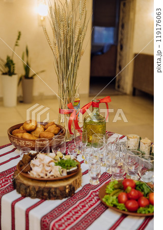 Traditional Ukrainian cuisine with lard, bread, vegetables, and meat on embroidered tablecloth Traditional Ukrainian cuisine with lard, bread, vegetables, and meat on embroidered tablecloth 119176063