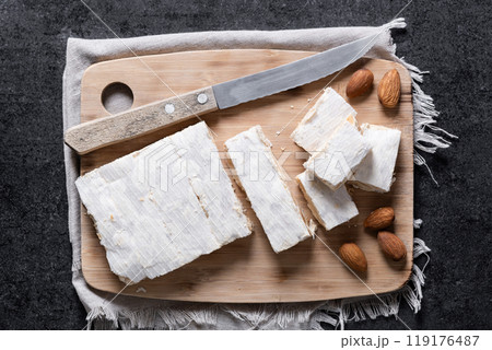 Christmas almond nougat on black slate background Christmas almond nougat on black slate background 119176487