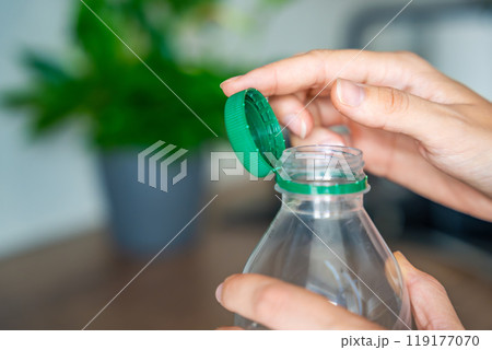 Stationary plastic cap on a PET bottle. The new design means the cap remains attached to the bottle after opening, making the entire package easier to collect and recycle Stationary plastic cap on a PET bottle. The new design means the cap remains attached to the bottle after opening, making the entire package easier to collect and recycle 119177070
