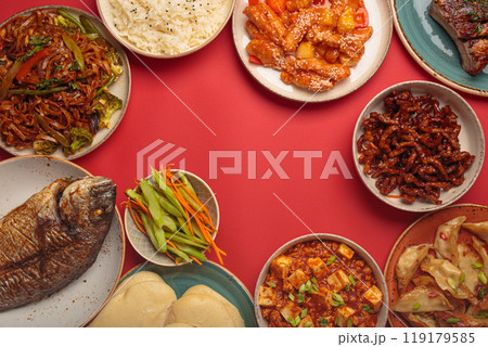 Assorted traditional chinese dishes top view on red background: kung pal chicken, sweet and sour pork, noodles, dumplings, mapo tofu, fish, rice 119179585