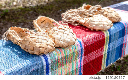 Wicker bast shoes  on the vintage homespun doormat 119180527
