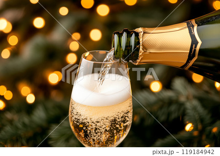 Glass being filled with sparkling champagne, surrounded by a bokeh festive background, the essence of celebration Glass being filled with sparkling champagne, surrounded by a bokeh festive background, the essence of celebration 119184942