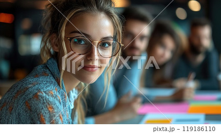 Innovative start-up team engaged in creative brainstorming in a modern co-working space. 119186110