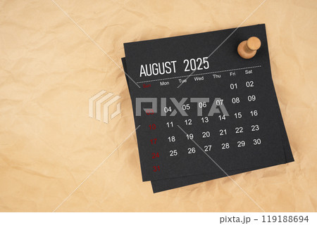 Black calendar sheet for August 2025 with thumbtack on brown paper crumpled. Black calendar sheet for August 2025 with thumbtack on brown paper crumpled. 119188694