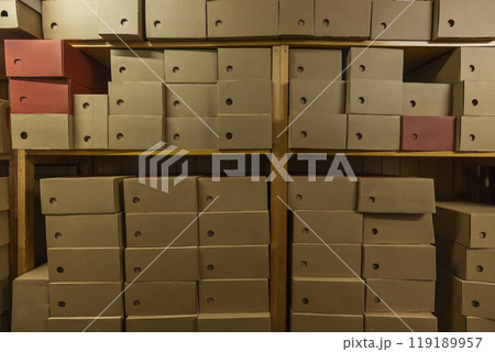 Efficient storage in a small shop filled with organized cardboard boxes Efficient storage in a small shop filled with organized cardboard boxes 119189957