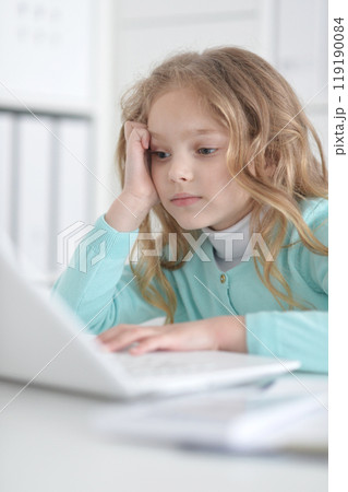 Cute and happy little girl children using laptop computer Cute and happy little girl children using laptop computer 119190084
