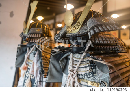 Traditional Japanese samurai armor and mask decor inside building 119190398