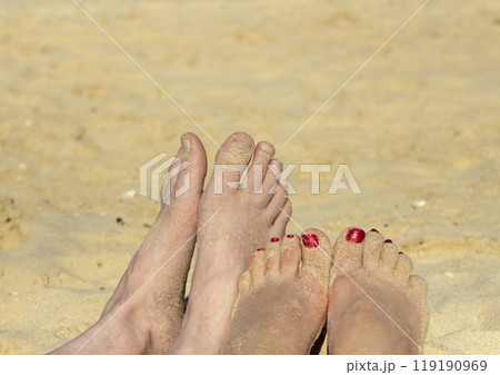 Feet on the beach 119190969