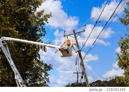 There is power outage following severe violent hurricane that damaged power line that has to be repaired by emergency workers 119191191