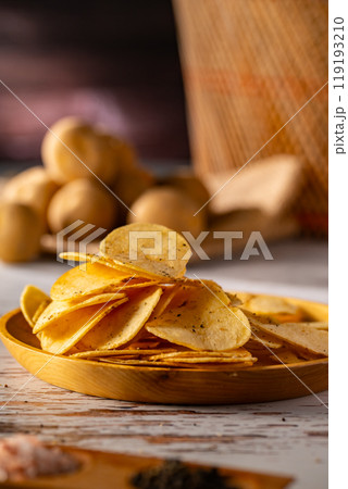 Potato chips on a wooden table. Potato chips on a wooden table. 119193210