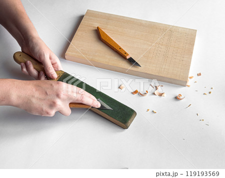 Precision knife sharpening and woodworking craftsmanship scene 119193569