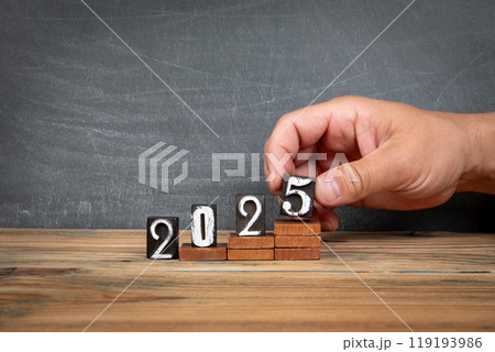 2025. Wooden letters, alphabet blocks on steps. development and growth concept 119193986