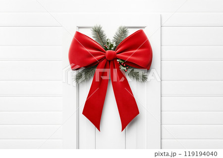 Festive red bow adorned with pinecones and greenery, set against a light background, showcasing Christmas holiday spirit 119194040