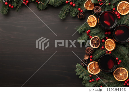 Christmas wreath with mulled wine and dried orange slices on a dark wooden background. Festive decorations Christmas wreath with mulled wine and dried orange slices on a dark wooden background. Festive decorations 119194168