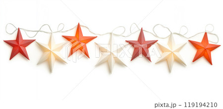 Decorative white Christmas stars with golden accents and fairy lights on white background. Festive holiday decor concept 119194210