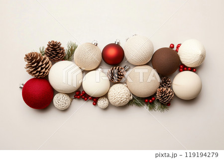 Christmas ornaments and pine cones arranged aesthetically on a white background. Holiday decor concept 119194279