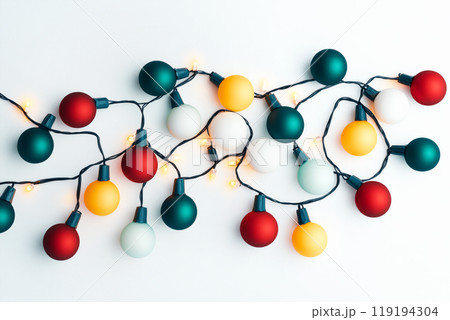 Collection of Christmas lights on a green wire isolated on white background, perfect for festive decorations Collection of Christmas lights on a green wire isolated on white background, perfect for festive decorations 119194304