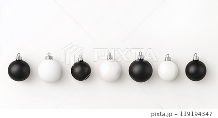 Glossy black and white ornaments suspended on thin strings on white background, showcasing a modern Christmas aesthetic 119194347