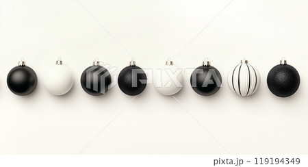 Glossy black and white ornaments suspended on thin strings on white background, showcasing a modern Christmas aesthetic Glossy black and white ornaments suspended on thin strings on white background, showcasing a modern Christmas aesthetic 119194349