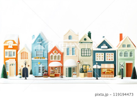 Miniature winter village with various houses, trees, and figurines on a white snowy background. Festive holiday decor 119194473
