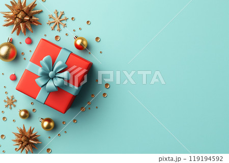 Red gifts with blue bows and golden ornaments on vibrant blue backdrop, creating a cheerful Christmas holiday atmosphere 119194592