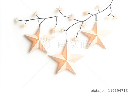 Decorative white Christmas stars with golden accents and fairy lights on white background. Festive holiday decor concept 119194718