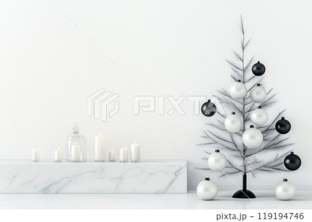 Minimalist Christmas tree with black and white ornaments stands next to a marble shelf adorned with lit candles Minimalist Christmas tree with black and white ornaments stands next to a marble shelf adorned with lit candles 119194746