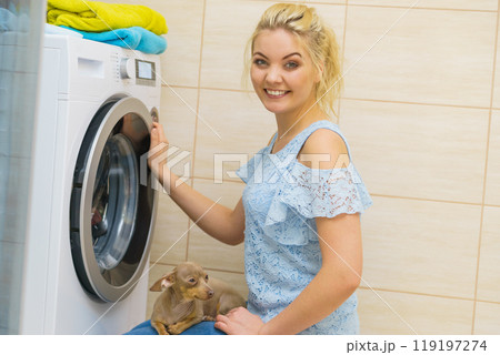Woman setting washing machine 119197274