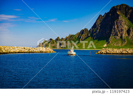 Seascape with fishing boat and stone breakwater 119197423