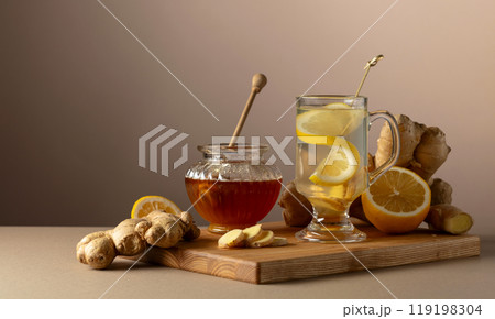 Ginger tea with lemon and honey on a beige background. Ginger tea with lemon and honey on a beige background. 119198304