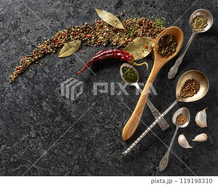 Mix of organic dried spices on a black stone background. 119198310