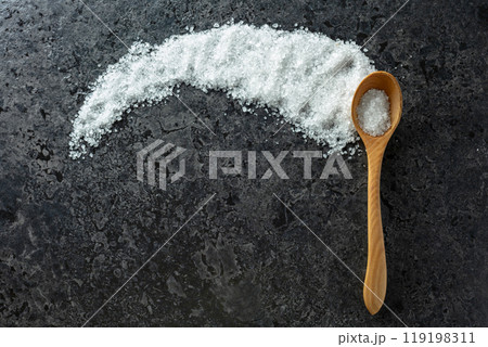 Sea salt on a black stone background. 119198311