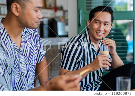 A group of friends happily enjoying refreshing beverages in a casual atmosphere A group of friends happily enjoying refreshing beverages in a casual atmosphere 119200975