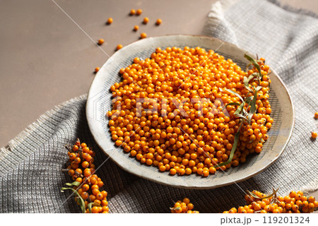 A plate with berries stands on a table with a gray napkin A plate with berries stands on a table with a gray napkin 119201324