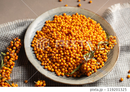 A plate with berries on a table with a gray napkin A plate with berries on a table with a gray napkin 119201325