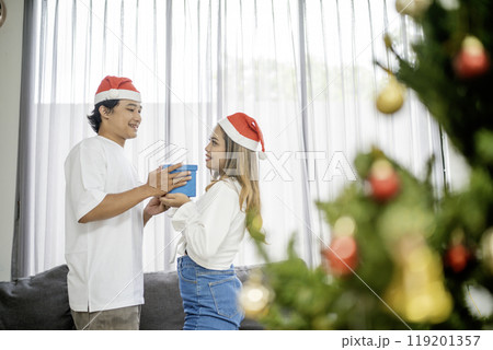 asian man giving christmas gift girlfriend asian man giving christmas gift girlfriend 119201357