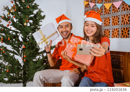 Joyful Holiday Celebration Filled with Gifts, Laughter, and Christmas Cheer Joyful Holiday Celebration Filled with Gifts, Laughter, and Christmas Cheer 119201636