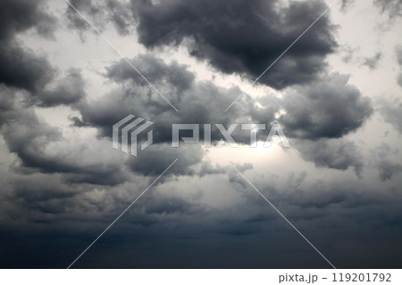 Dramatic gray sky with black clouds hiding the sun Dramatic gray sky with black clouds hiding the sun 119201792
