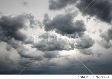 Dramatic gray sky with clouds hiding the sun Dramatic gray sky with clouds hiding the sun 119201793